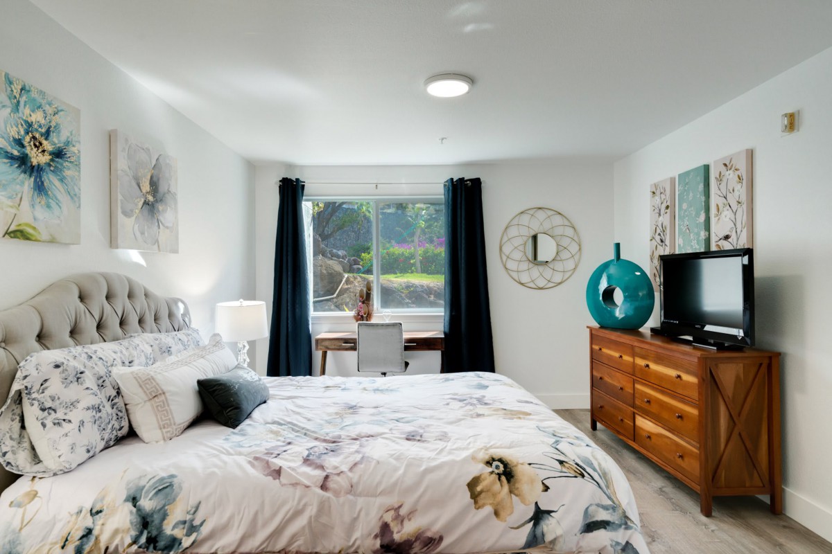 A well-decorated bedroom with a double bed, window, and modern furnishings.