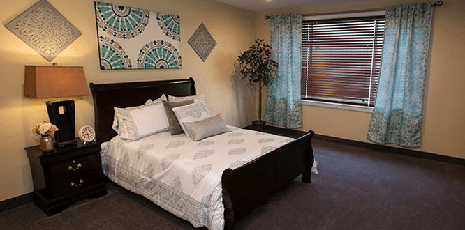 A modern bedroom with elegant furnishings and decor.