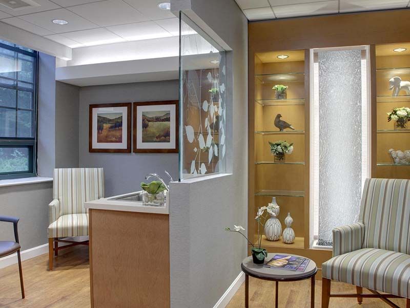 A modern waiting room with comfortable seating and decorative elements.