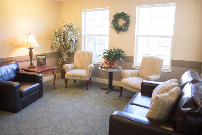 A cozy living room with comfortable seating and decorative elements.