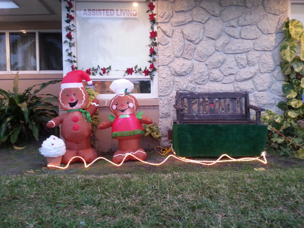 Festive outdoor Christmas decorations featuring gingerbread figures and holiday lights.