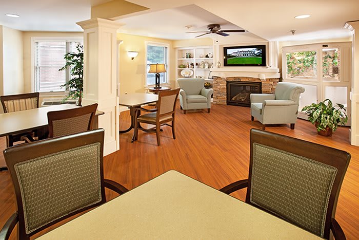A cozy living room with comfortable seating, a fireplace, and a television.