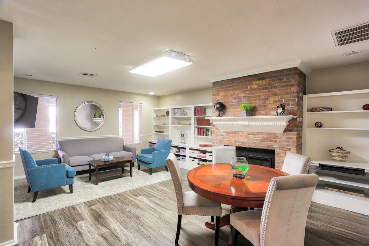 A modern living room with a cozy fireplace, comfortable seating, and stylish decor.