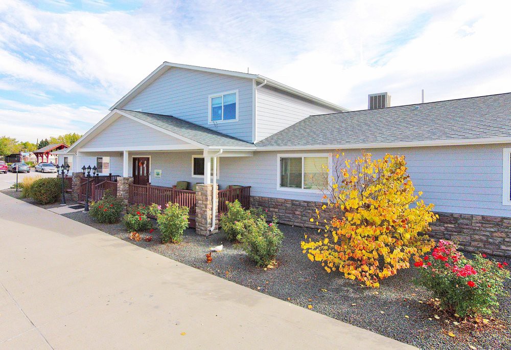 A modern residential house with a landscaped front yard and driveway.