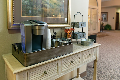A cozy coffee station equipped with a beverage dispenser and various snacks, adding charm to the interior space.