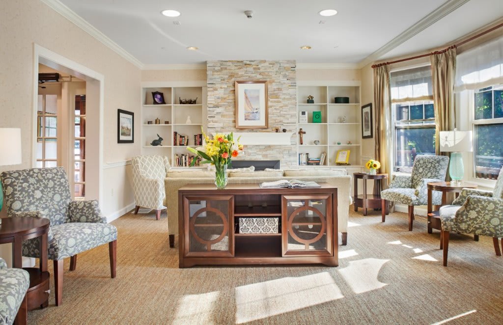 A modern living room with stylish furniture and a cozy fireplace.