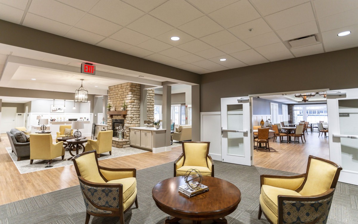 A comfortable and inviting lounge area with cushioned chairs and a central table.