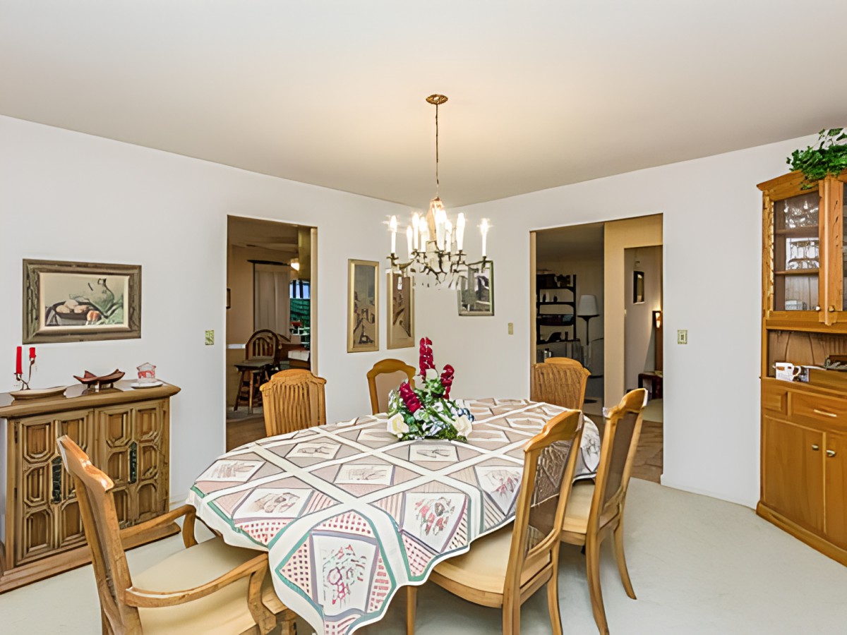 A classic dining room with a decorated table and chandelier.