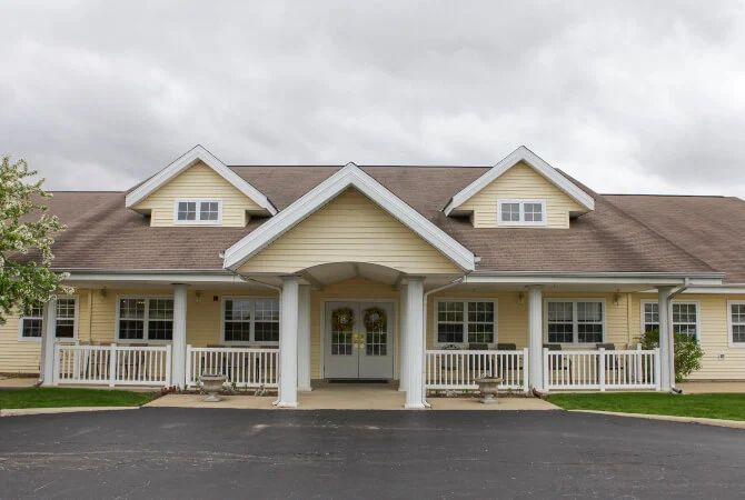 A suburban residential house with a porch and multiple gables.