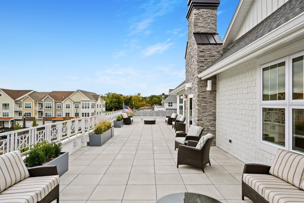 Spacious terrace with outdoor seating and a view of nearby buildings.