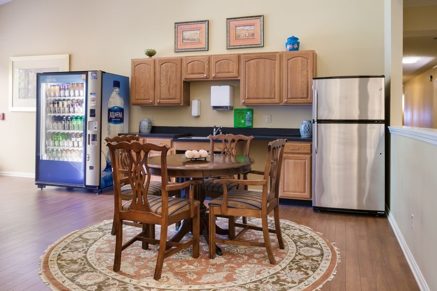 Cozy kitchen area with wooden dining set and modern appliances.