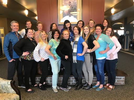 A cheerful group of women posing together in a warm, welcoming environment.