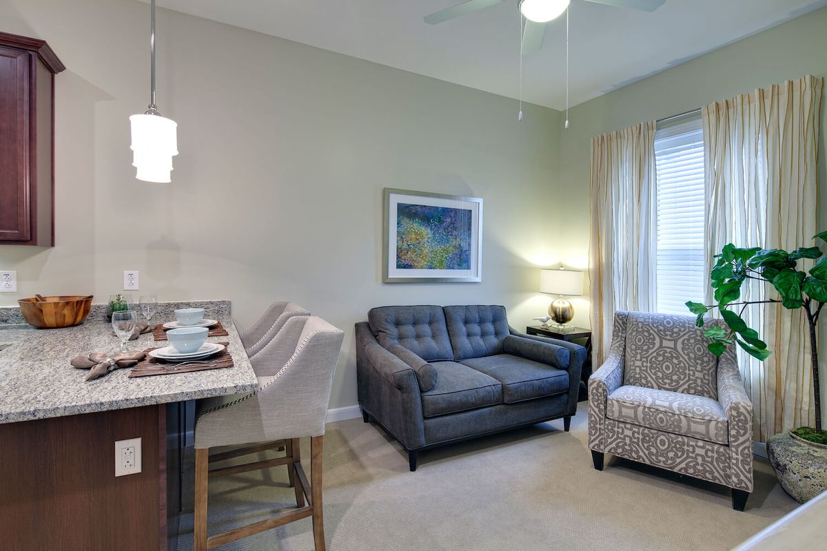 A cozy living room with modern furniture and stylish decor.