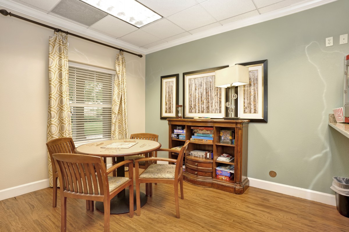 A cozy dining area with wooden furniture and decorative artwork.