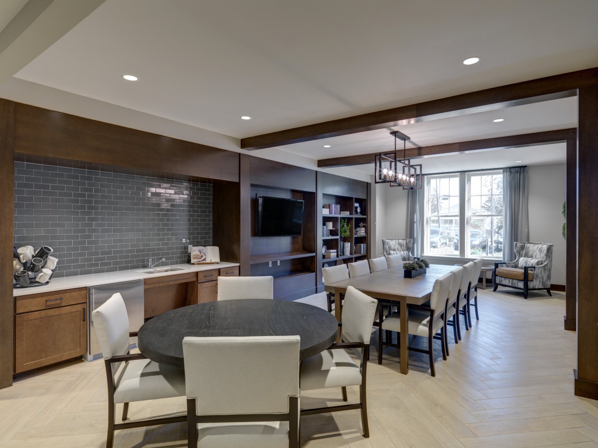 A modern open-concept living and dining area with contemporary furniture and ample natural light.