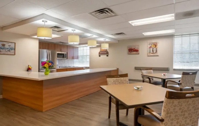 A modern kitchen and dining area with wooden furniture and bright lighting.