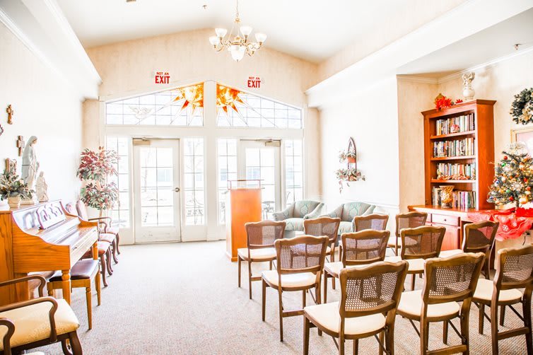 A bright and inviting lecture room with a seating arrangement, podium, and large windows letting in natural light.