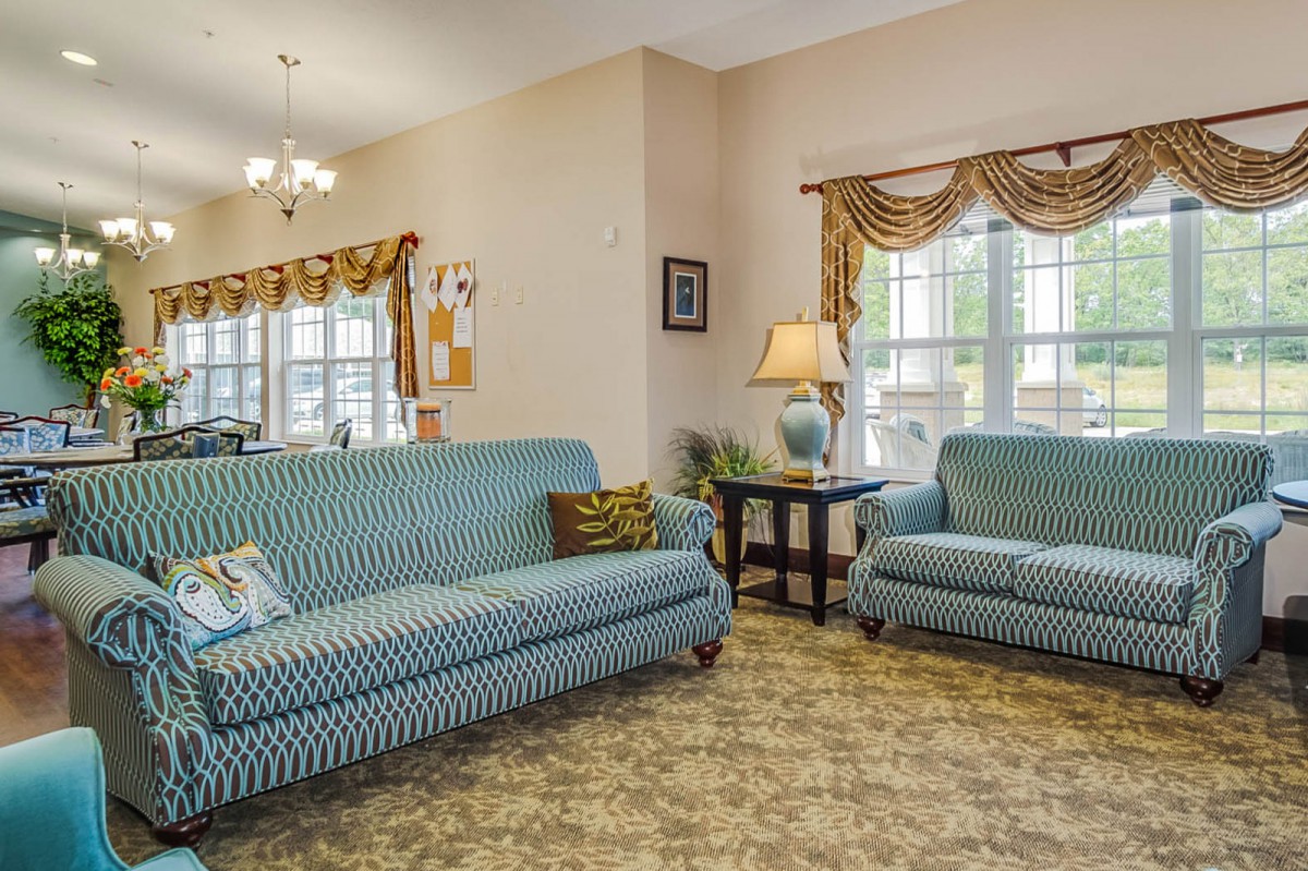 A cozy living room with blue striped sofas and elegant decor.