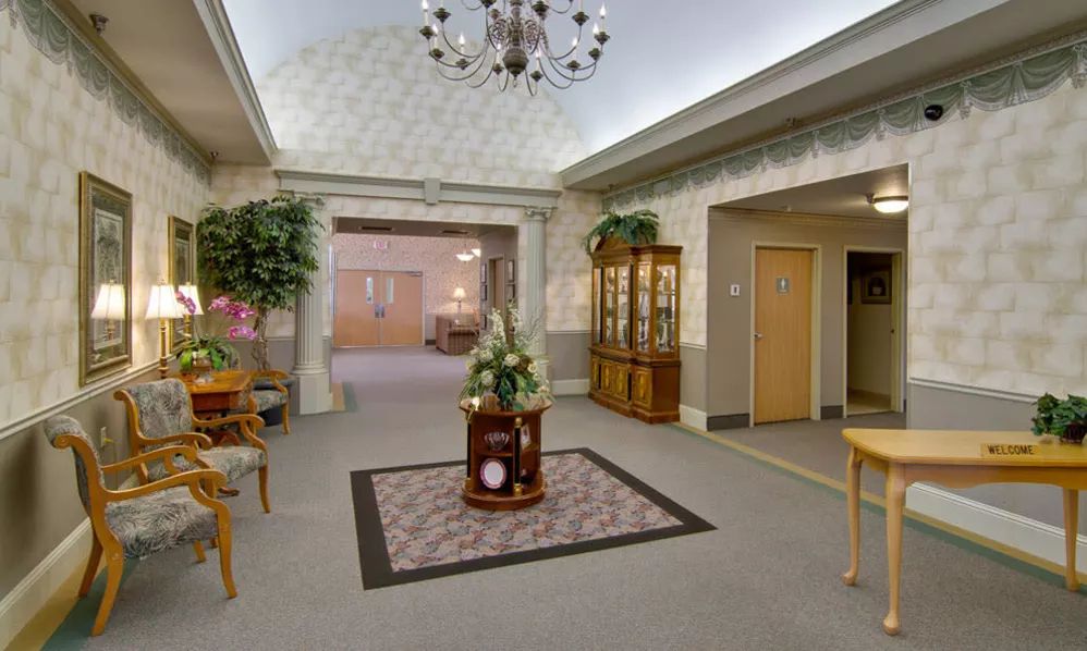 A well-decorated lobby with elegant furniture and greenery.