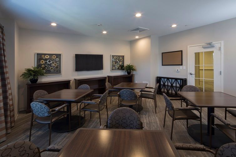 A modern conference room with tables and chairs arranged for meetings.