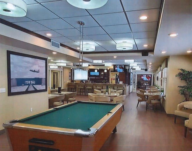 A well-furnished recreation room featuring a pool table and cozy seating arrangement.