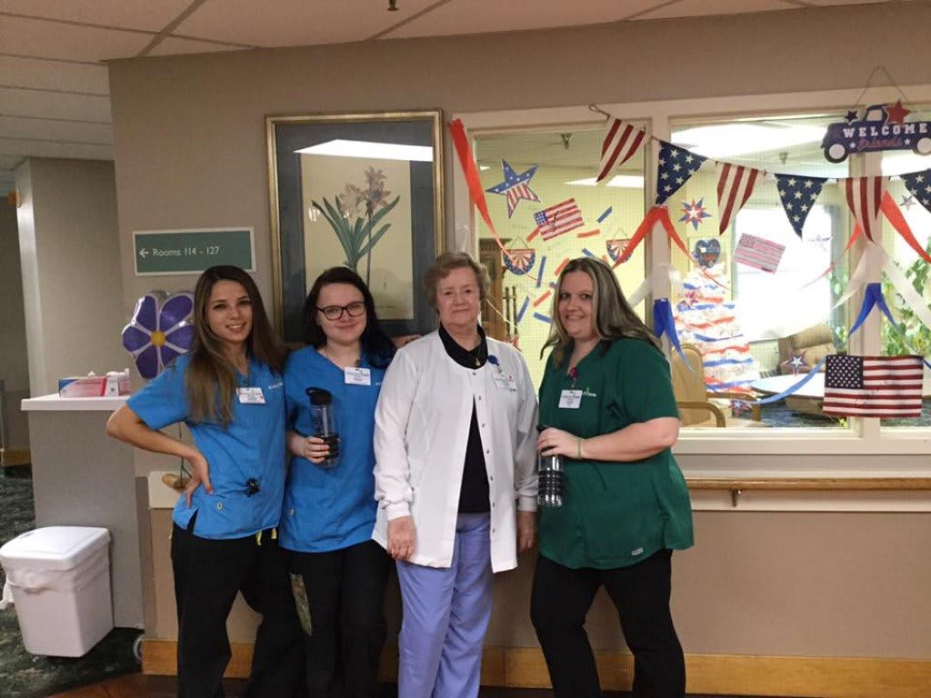A group of healthcare professionals posing together in a hospital setting.