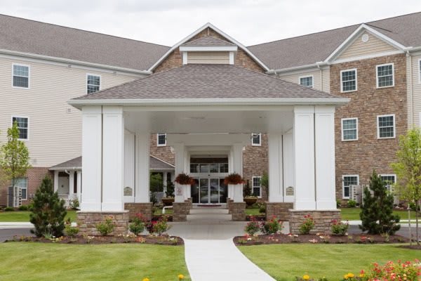 Entrance of a modern building with a landscaped walkway.