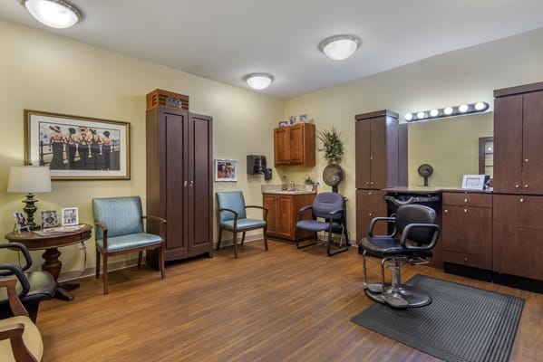 A cozy hair salon interior with mirrors, chairs, and a waiting area.