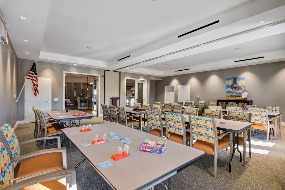 A conference room set up with tables and chairs, ready for a meeting or educational session.