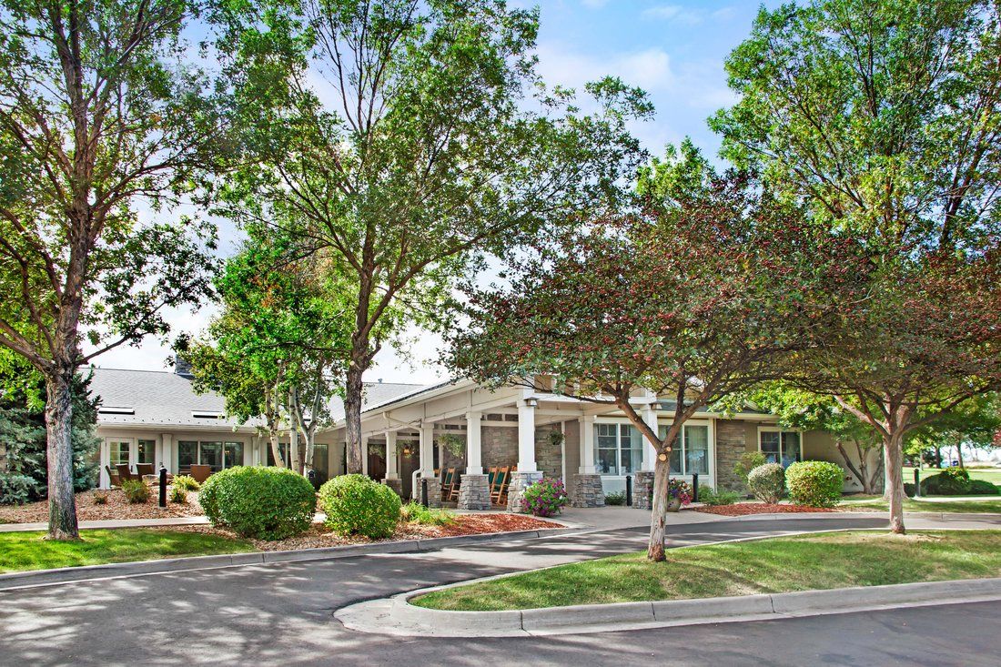 A scenic view of a building surrounded by trees and lush landscaping.
