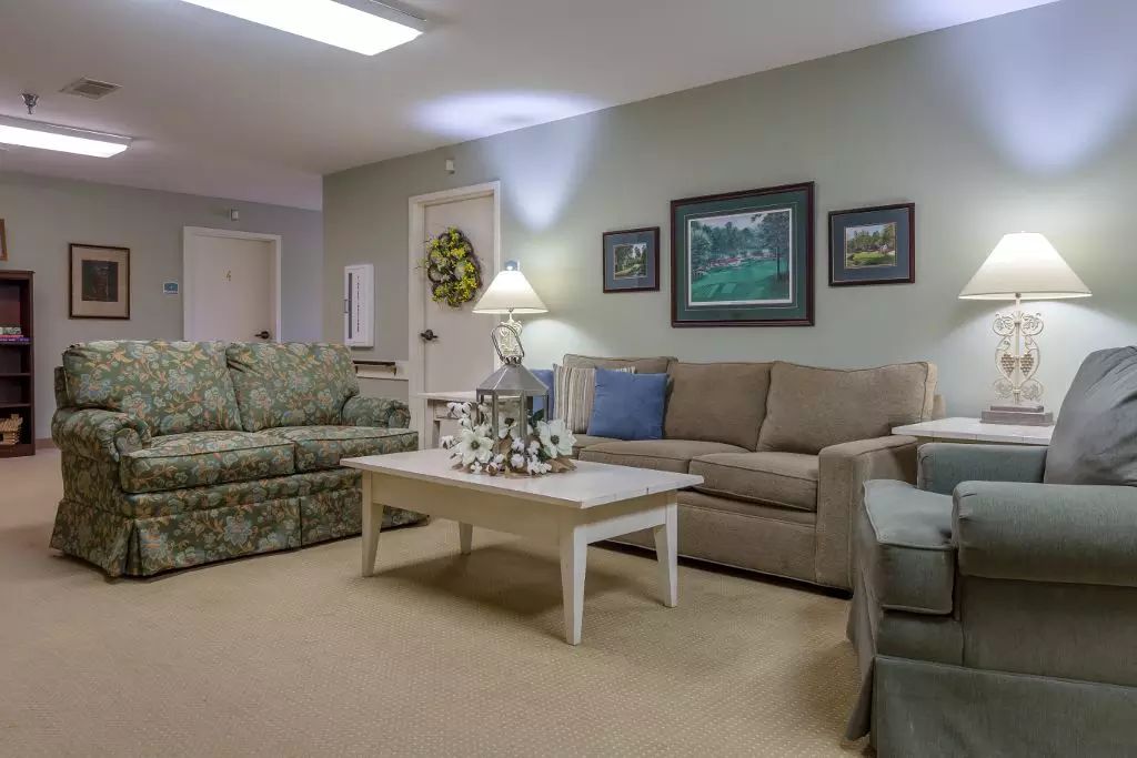 A cozy living room with sofas, a coffee table, and wall art.
