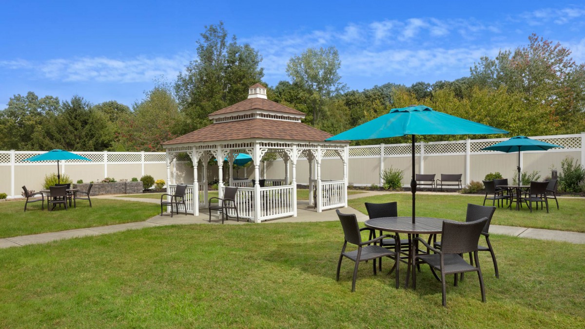 A peaceful garden setting featuring a gazebo and outdoor seating area.