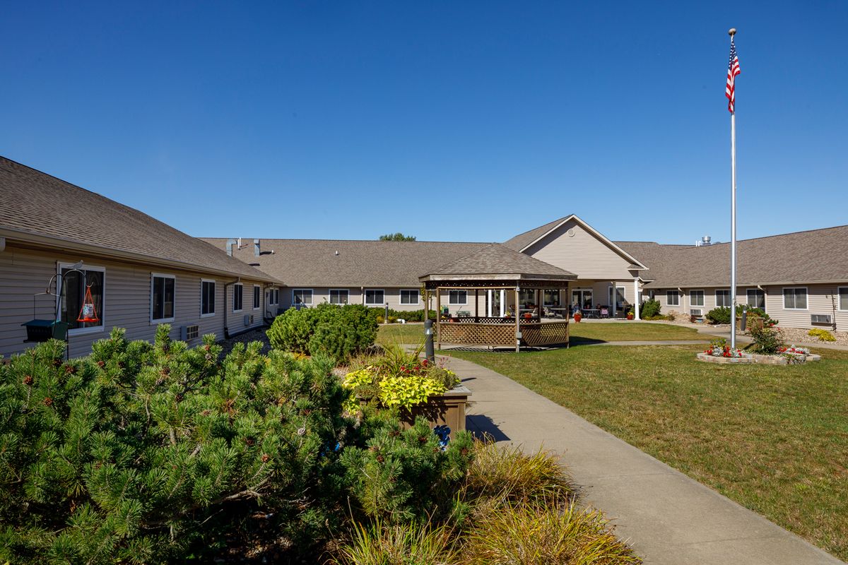 A well-maintained courtyard with pathways and landscaping, surrounded by a single-story building.