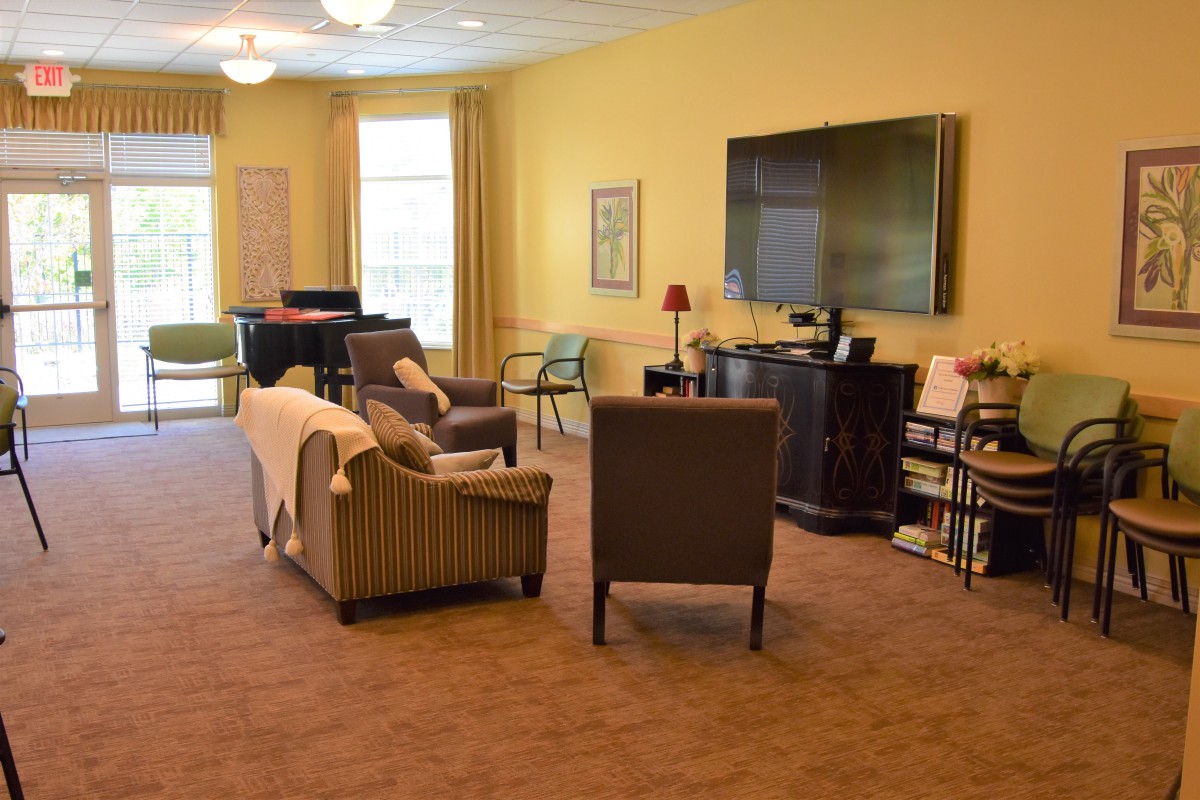 A cozy living room with comfortable seating and a large television.