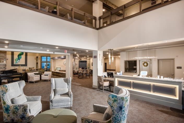 A modern and elegant lobby with comfortable seating areas and a reception desk.