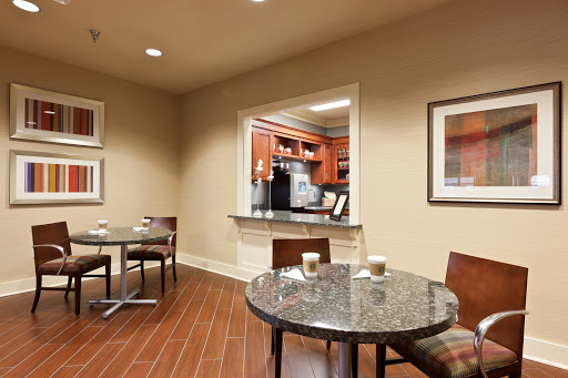 A cozy reception area featuring a granite table and warm wooden accents.