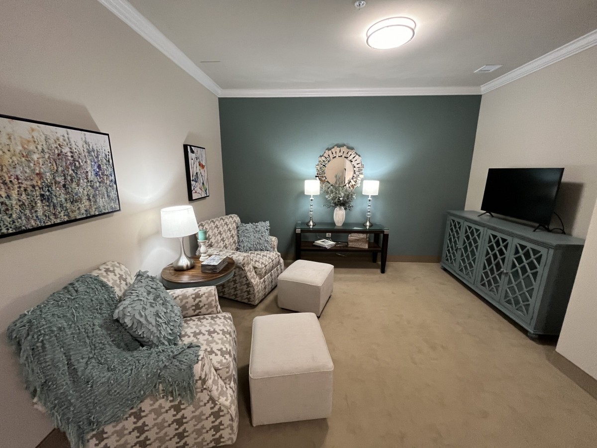 A cozy living room with patterned furniture and soft lighting.