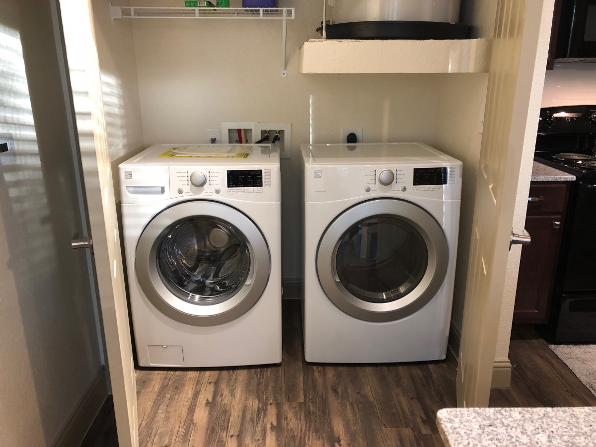 A laundry room with a washer and dryer side by side.