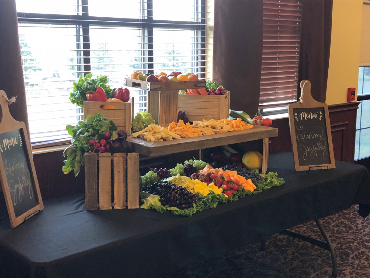 A beautifully arranged buffet display of fresh fruits and vegetables.