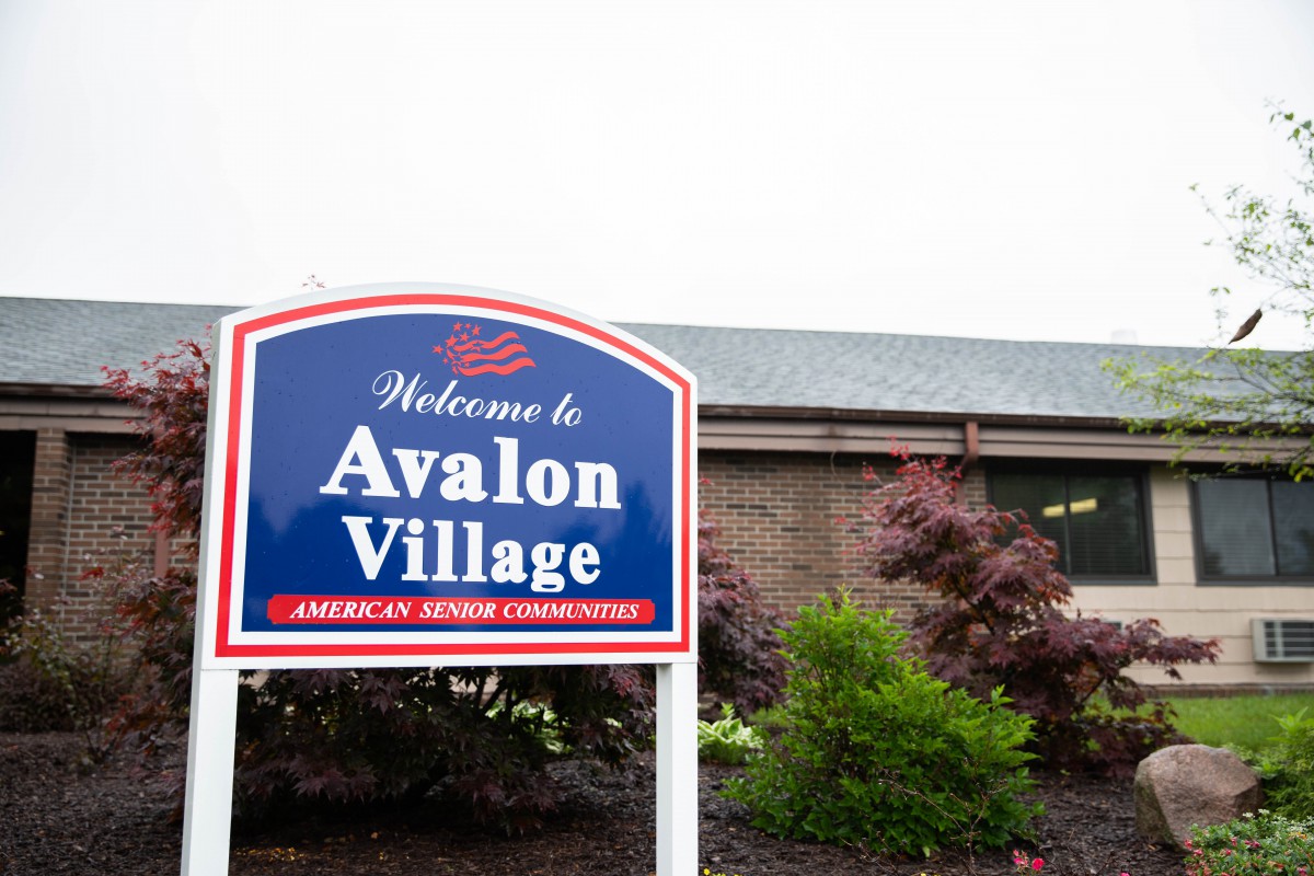 Welcome sign for Avalon Village, an American Senior Community.