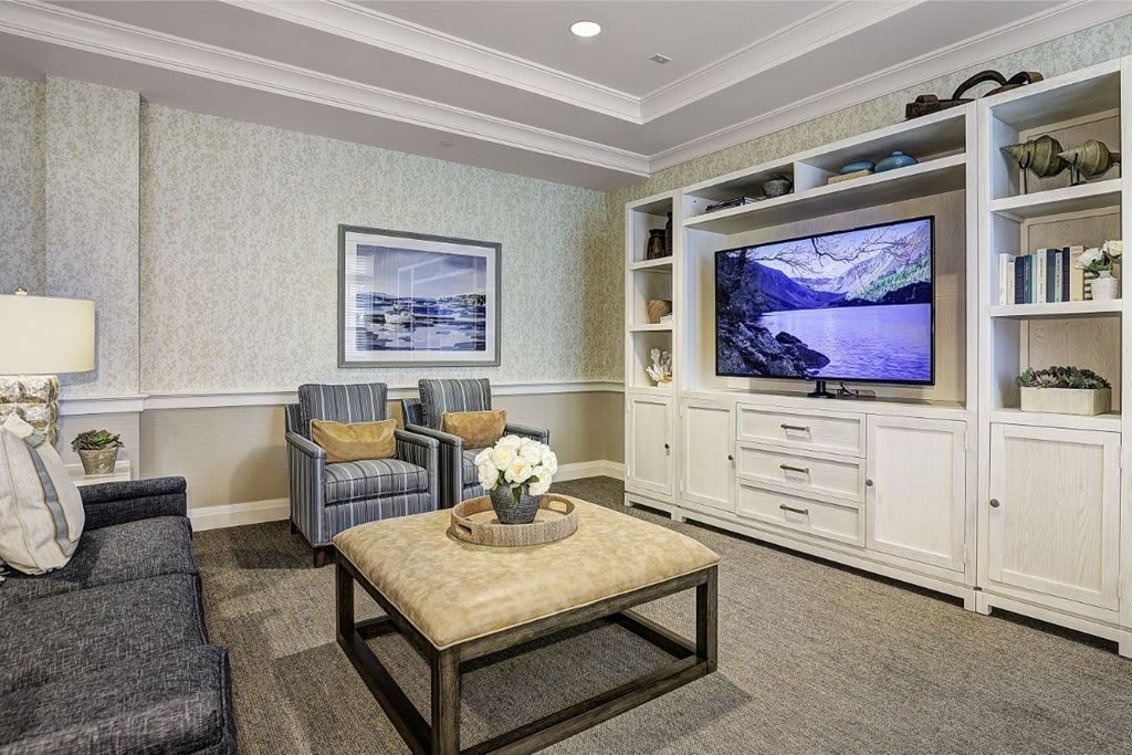A cozy living room with a television, comfortable seating, and stylish decor.