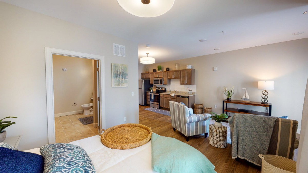 A cozy apartment interior featuring a living room and kitchen area with modern decor.