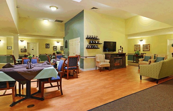 A cozy living and dining area with comfortable seating, a television, and tasteful decor.