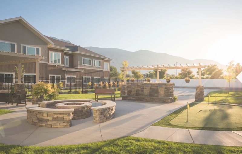 A serene outdoor residential setting with a fire pit and mountain views.