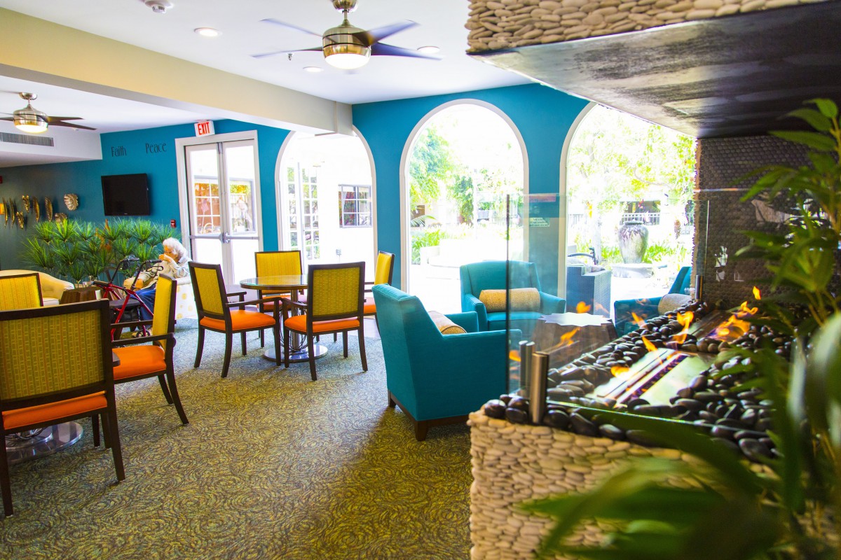 A vibrant lounge area featuring colorful seating and large windows providing natural light.