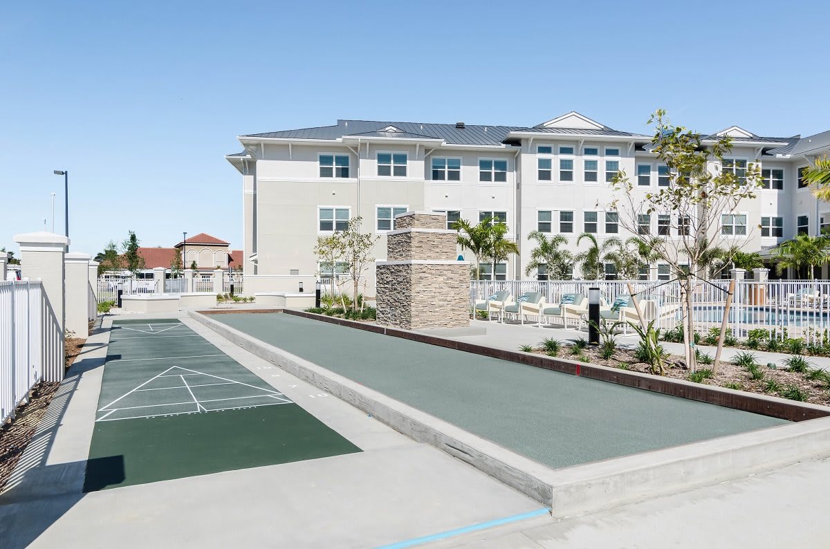 A modern building with an outdoor recreation area featuring a sports court.