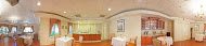 A spacious room with modern decor and a wooden floor.