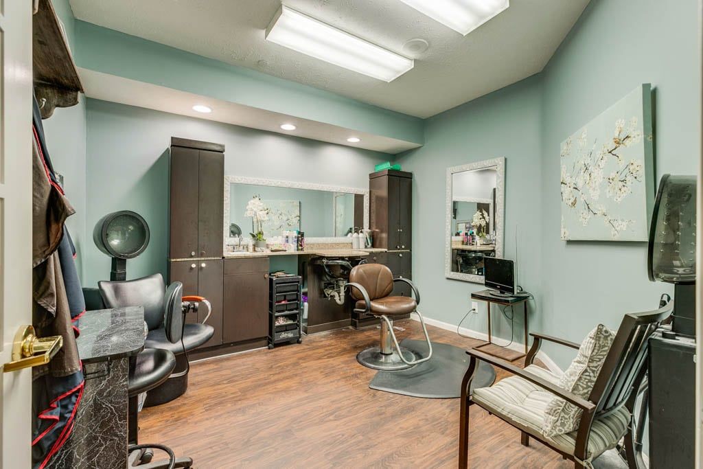 A well-organized hair salon interior with a styling station and comfortable seating.