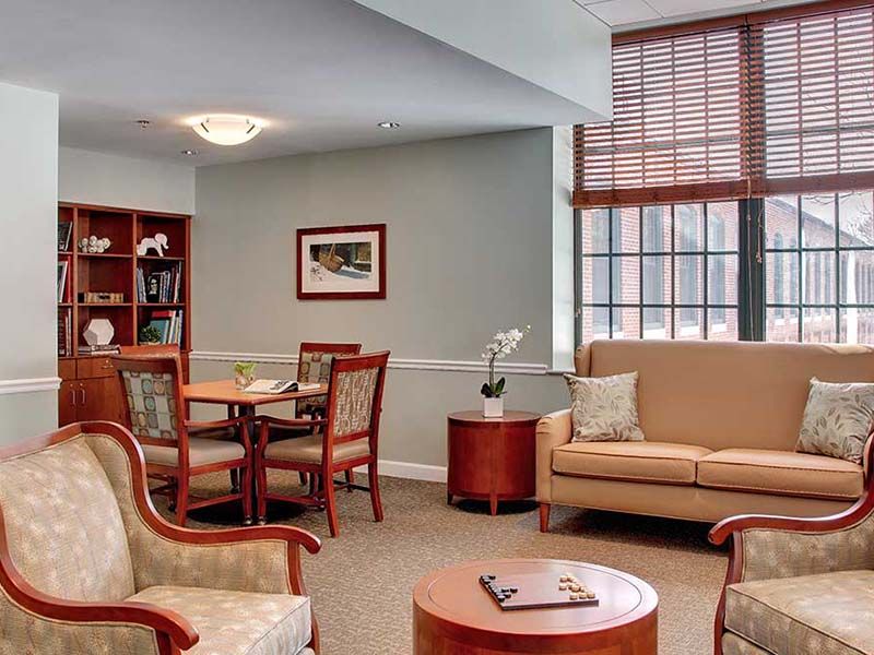 A cozy living room with comfortable seating and a bookshelf.