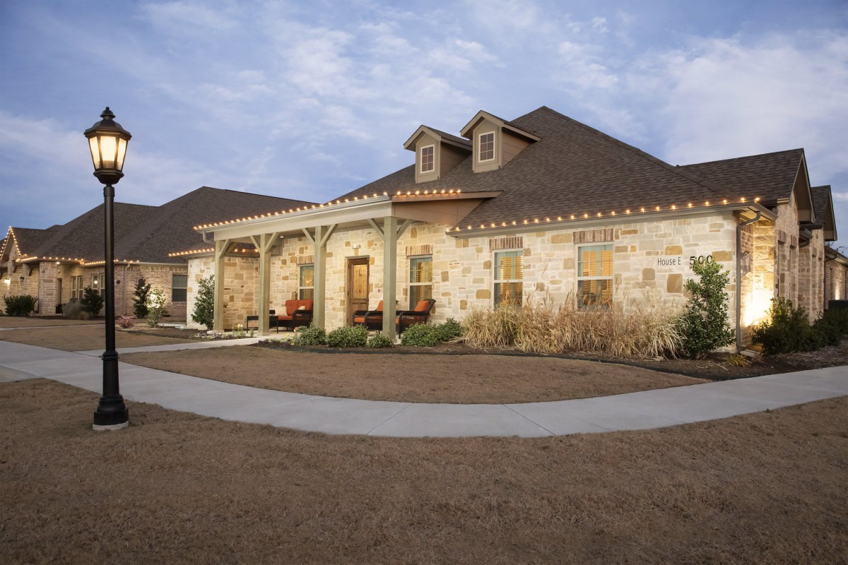 A beautiful stone-exterior suburban house with a welcoming front porch.